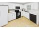 Efficient kitchen featuring white cabinetry, black appliances, and a well-lit countertop area at 2541 26Th Ne Ave, Hickory, NC 28601