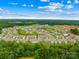 Aerial view of a new residential community surrounded by lush greenery and featuring a pool at 2717 Aubrey St, Monroe, NC 28110