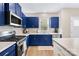 Modern kitchen featuring blue cabinets, stainless appliances, and a gas range at 2717 Aubrey St, Monroe, NC 28110