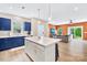Bright, open kitchen with navy cabinets, an island, stainless appliances, and hardwood floors at 2717 Aubrey St, Monroe, NC 28110