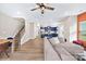 Open-concept living space featuring hardwood floors, a staircase, and a modern kitchen at 2717 Aubrey St, Monroe, NC 28110