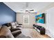 Modern living room featuring wood floors, a comfortable sofa, and a large TV at 2717 Aubrey St, Monroe, NC 28110