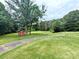 Expansive backyard with lush greenery, mature trees, shed and hammock, perfect for outdoor relaxation at 3115 Falling Creek Rd, Hickory, NC 28601