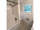 Bathroom featuring a white tiled shower and a window at 3115 Falling Creek Rd, Hickory, NC 28601