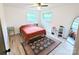 Bedroom with laminate flooring, ceiling fan, two windows, and area rug at 3115 Falling Creek Rd, Hickory, NC 28601