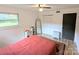 Bedroom featuring laminate flooring, a ceiling fan, two windows, and a closet at 3115 Falling Creek Rd, Hickory, NC 28601