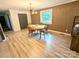 Stylish dining room features an accent wall, laminate floors, and modern lighting for a sophisticated look at 3115 Falling Creek Rd, Hickory, NC 28601