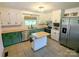 Bright kitchen featuring two-toned cabinets, stainless steel appliances, and a butcher block countertop island at 3115 Falling Creek Rd, Hickory, NC 28601