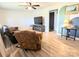Cozy living room featuring wood flooring, a comfortable recliner and a wall-mounted TV, perfect for relaxation at 3115 Falling Creek Rd, Hickory, NC 28601