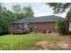 Brick home featuring a wood deck, with a large grassy backyard and mature trees at 328 Burrage Ne Rd, Concord, NC 28025