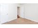Bedroom with neutral carpet, white trim, and access to another room at 328 Burrage Ne Rd, Concord, NC 28025