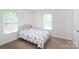 Bedroom with carpet, two windows and a gold colored bed frame at 328 Burrage Ne Rd, Concord, NC 28025