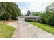 Charming brick home with a welcoming front porch and long driveway, surrounded by mature trees at 328 Burrage Ne Rd, Concord, NC 28025