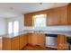 The kitchen features wooden cabinets, stainless steel appliances, and solid surface countertops at 328 Burrage Ne Rd, Concord, NC 28025