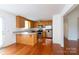 Cozy kitchen featuring wood cabinets, stainless steel appliances, and an adjacent breakfast bar at 328 Burrage Ne Rd, Concord, NC 28025