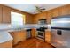 Well-lit kitchen featuring oak cabinets, stainless steel appliances, and ample counter space at 328 Burrage Ne Rd, Concord, NC 28025