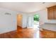 Bright kitchen featuring hardwood floors, white walls, and access to the outdoor deck at 328 Burrage Ne Rd, Concord, NC 28025