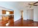 A combined view of the living room and kitchen, featuring hardwood floors and modern appliances at 328 Burrage Ne Rd, Concord, NC 28025