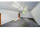 Loft area with gray carpet, gray paneling, and a window for natural light at 336 Oakwood Dr, Mount Holly, NC 28120