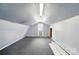 Finished attic or bonus room in barn, with gray carpeting and natural light at 336 Oakwood Dr, Mount Holly, NC 28120
