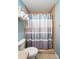 Bathroom featuring a toilet and a shower with a striped curtain and a towel rack at 336 Oakwood Dr, Mount Holly, NC 28120