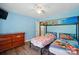 Bright bedroom featuring a bunk bed, light blue walls, and a dark wood dresser at 336 Oakwood Dr, Mount Holly, NC 28120