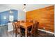 Cozy dining room featuring wood accent wall, pendant lighting, and wood table set for six at 336 Oakwood Dr, Mount Holly, NC 28120