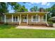 Inviting front porch with white railing and natural wood, leading to a charming home entrance at 336 Oakwood Dr, Mount Holly, NC 28120