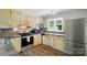 Charming kitchen with stainless steel appliances, unique countertops and ample storage at 336 Oakwood Dr, Mount Holly, NC 28120
