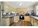 Well-lit kitchen with stainless steel appliances, ample storage, and tile backsplash at 336 Oakwood Dr, Mount Holly, NC 28120