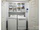 Well-organized laundry room with washer, dryer, and ample storage shelves at 336 Oakwood Dr, Mount Holly, NC 28120