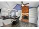 Comfortable living room with vaulted ceilings, brick fireplace, and ample seating at 336 Oakwood Dr, Mount Holly, NC 28120