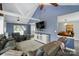 Spacious living room with vaulted ceilings, ceiling fan, modern furnishings, and a view to the kitchen at 336 Oakwood Dr, Mount Holly, NC 28120