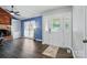 Spacious living room with a brick fireplace, built-in shelving, and a bright front door at 336 Oakwood Dr, Mount Holly, NC 28120