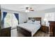 Bright main bedroom features ceiling fan, hardwood floors and natural light at 336 Oakwood Dr, Mount Holly, NC 28120