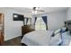 Bright main bedroom features ceiling fan, hardwood floors, and mounted television at 336 Oakwood Dr, Mount Holly, NC 28120
