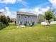 Large green backyard featuring a patio with outdoor dining, a grill, and blue outdoor seating at 417 Livingston Dr, Lancaster, SC 29720