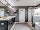 Stylish bathroom with double vanity, dark grey walls, and glass shower enclosure at 417 Livingston Dr, Lancaster, SC 29720
