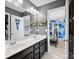 Bathroom with double sinks, dark cabinets, and a decorative framed mirror at 417 Livingston Dr, Lancaster, SC 29720