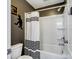 Clean bathroom featuring a white shower-tub with a stylish black-and-white striped curtain at 417 Livingston Dr, Lancaster, SC 29720