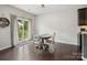 Cozy dining area with a round table, backyard access, and dark wood floors for an inviting atmosphere at 417 Livingston Dr, Lancaster, SC 29720