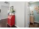 Bright hallway with hardwood floors, leading to a bathroom and featuring red accent table at 417 Livingston Dr, Lancaster, SC 29720