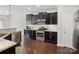 Contemporary kitchen with dark cabinetry, granite countertops, and stainless steel appliances for modern appeal at 417 Livingston Dr, Lancaster, SC 29720