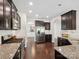 Modern kitchen featuring dark cabinets, stainless steel appliances, granite countertops, and open access to dining areas at 417 Livingston Dr, Lancaster, SC 29720