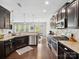 Stylish kitchen with dark cabinets, stainless steel appliances, granite countertops, and an open view to living area at 417 Livingston Dr, Lancaster, SC 29720