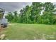 Expansive green backyard surrounded by mature trees, perfect for outdoor activities and privacy at 4511 Hunton Dale Nw Rd, Concord, NC 28027