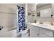 Bathroom with a shower-tub combination, white vanity, and stylish decorative accents at 4511 Hunton Dale Nw Rd, Concord, NC 28027