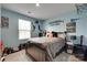 Teen bedroom with blue walls, sports-themed decor, and a comfortable bed at 4511 Hunton Dale Nw Rd, Concord, NC 28027