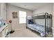 Spare bedroom with a bunk bed, neutral walls, and a bright window at 4511 Hunton Dale Nw Rd, Concord, NC 28027