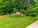 Beautiful Hunton Forest community sign with lush landscaping and stone detailing at 4511 Hunton Dale Nw Rd, Concord, NC 28027